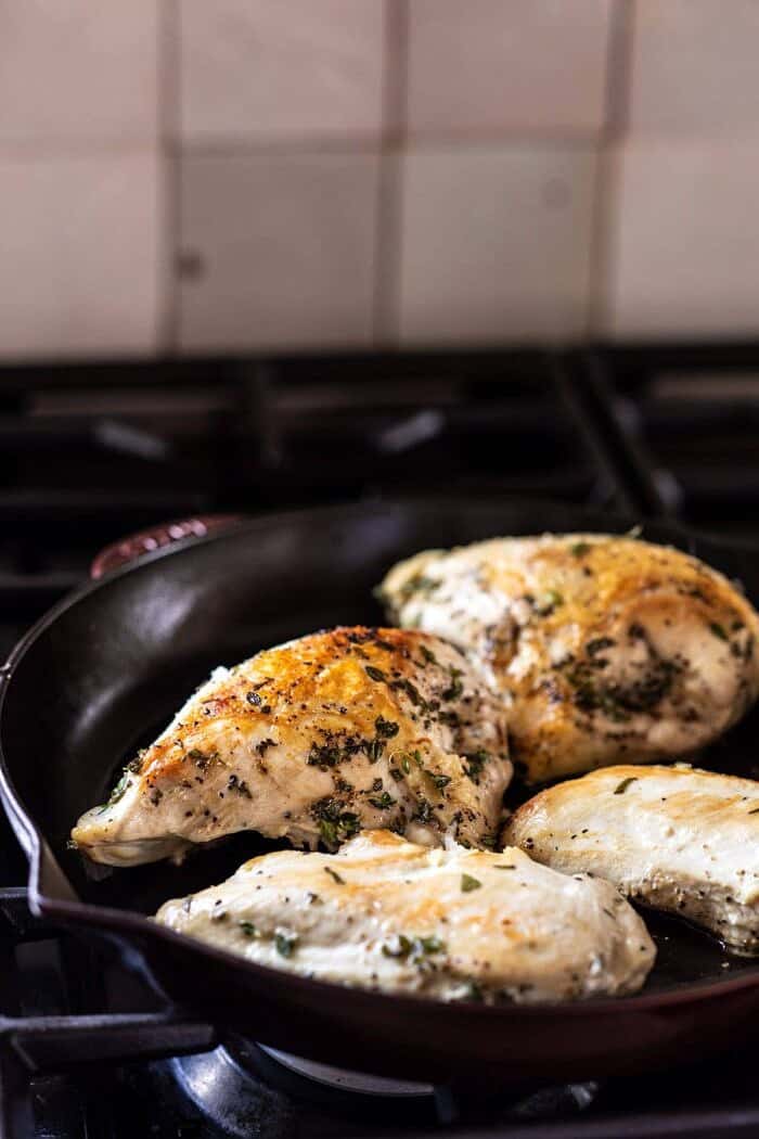 Slow Cooker French Wine and Mustard Chicken | halfbakedharvest.com #slowcooker #crockpot #instantpot #chicken side angled photo of chicken cooking in skillet