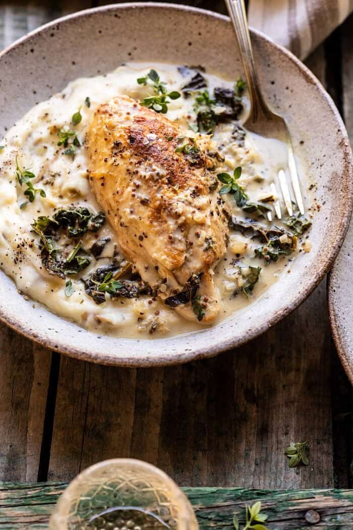 Slow Cooker French Wine and Mustard Chicken | halfbakedharvest.com #slowcooker #crockpot #instantpot #chicken side angled close up photo of Slow Cooker French Wine and Mustard Chicken in bowl with mashed potatoes