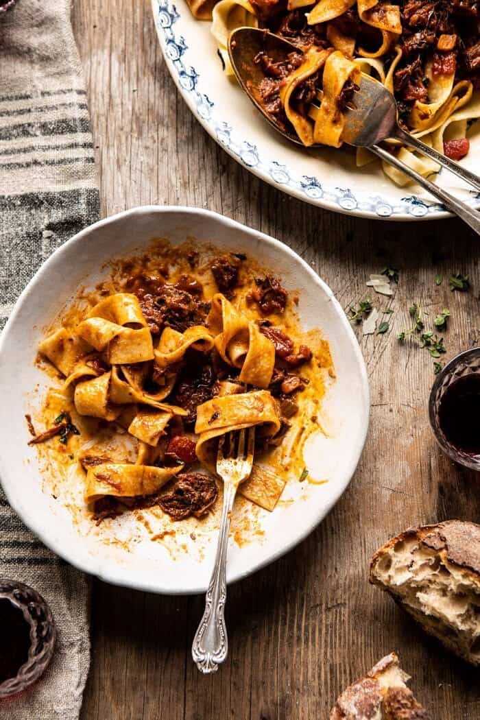Slow Cooker Red Wine Sunday Ragu Pasta | halfbakedharvest.com #pasta #ragu #Italian #slowcooker #crockpot #instantpot overhead photo of Slow Cooker Red Wine Sunday Ragu Pasta half eaten with fork in bowl