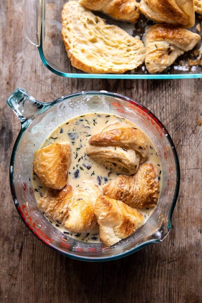 Ham and Cheese Croissant Bake | halfbakedharvest.com #brunch #breakfast #holiday #Christmas overhead photo of Ham and Cheese Croissants being tossed with egg batter