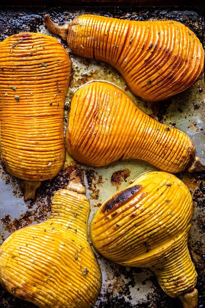 Hasselback Butternut Squash with Sage Butter and Prosciutto Breadcrumbs | halfbakedharvest.com #thanksgiving #sidedishes #butternutsquash Hasselback Butternut Squash on baking sheet