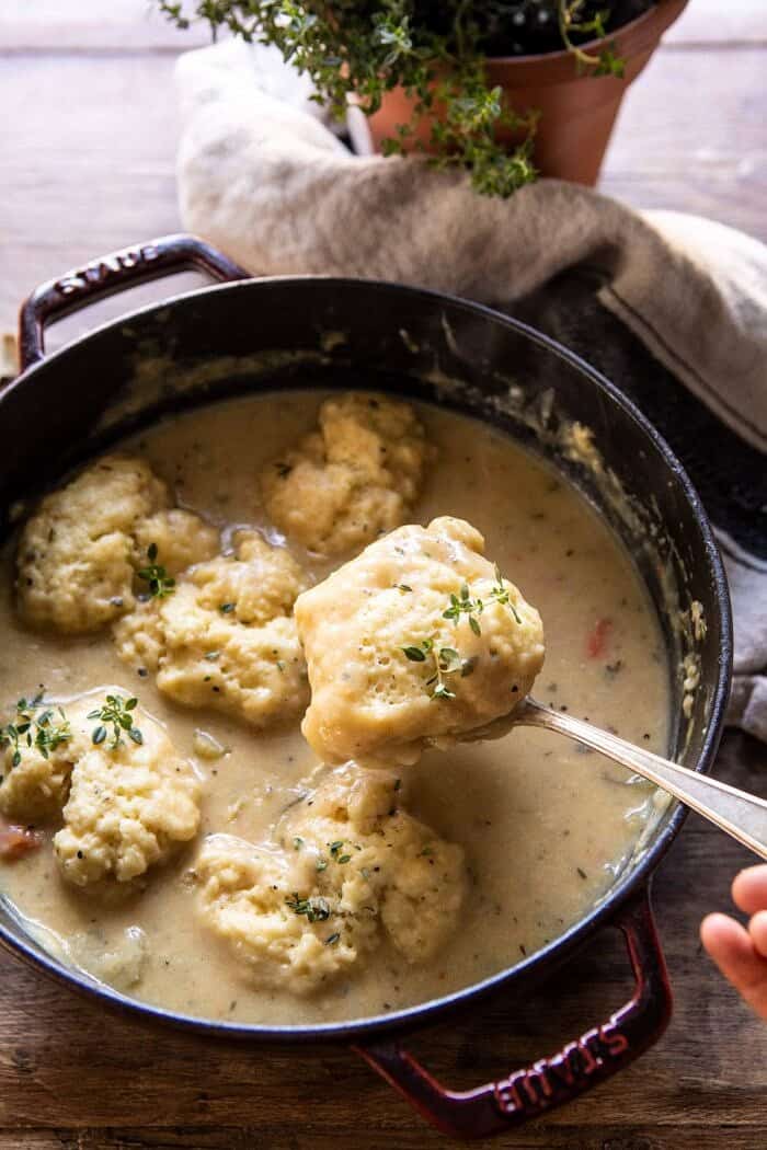 One Pot Creamy Turkey and Potato Dumplings | halfbakedharvest.com #turkey #dumplings #thanksgiving overhead photo of One Pot Creamy Turkey and Potato Dumplings with serving spoon spooning a dumpling out of the pot