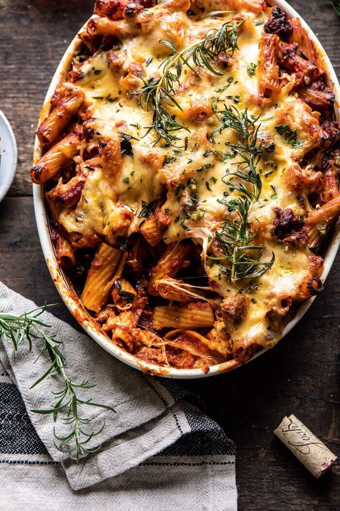 overhead close up photo of One Pot Spicy Pesto Cheese Baked Rigatoni with serving of pasta removed from baking dish