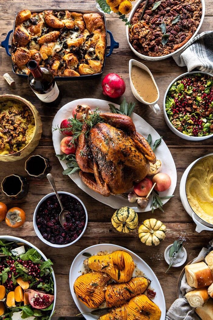 Our 2019 Thanksgiving Menu and Guide | halfbakedharvest.com #thanksgiving #thanksgivingmenu #holiday overhead photo of Our 2019 Thanksgiving Menu with roasted turkey in center of photo and sides around turkey