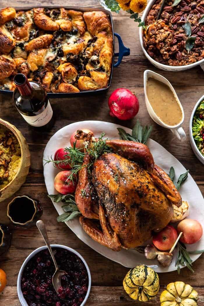 Our 2019 Thanksgiving Menu and Guide | halfbakedharvest.com #thanksgiving #thanksgivingmenu #holiday overhead close up photo of herb roasted turkey and stuffing
