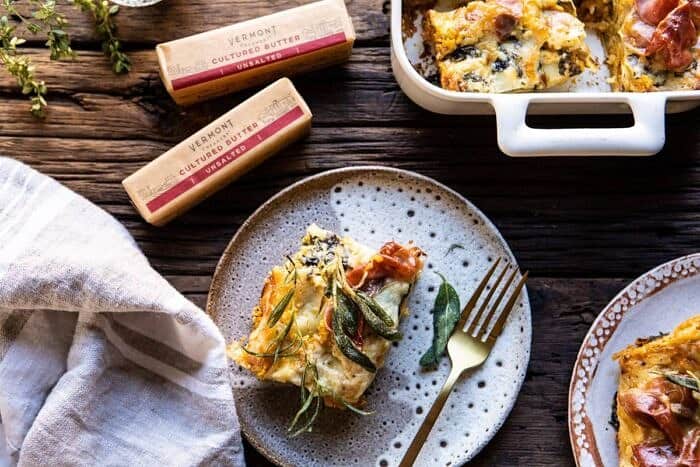 horizontal photo of Roasted Butternut Squash and Spinach Lasagna slice on serving plate with fork