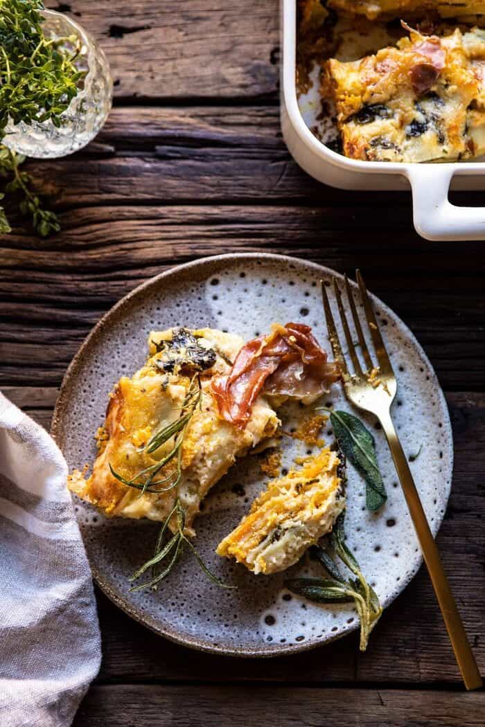 overhead photo of Roasted Butternut Squash and Spinach Lasagna slice on serving plate with fork