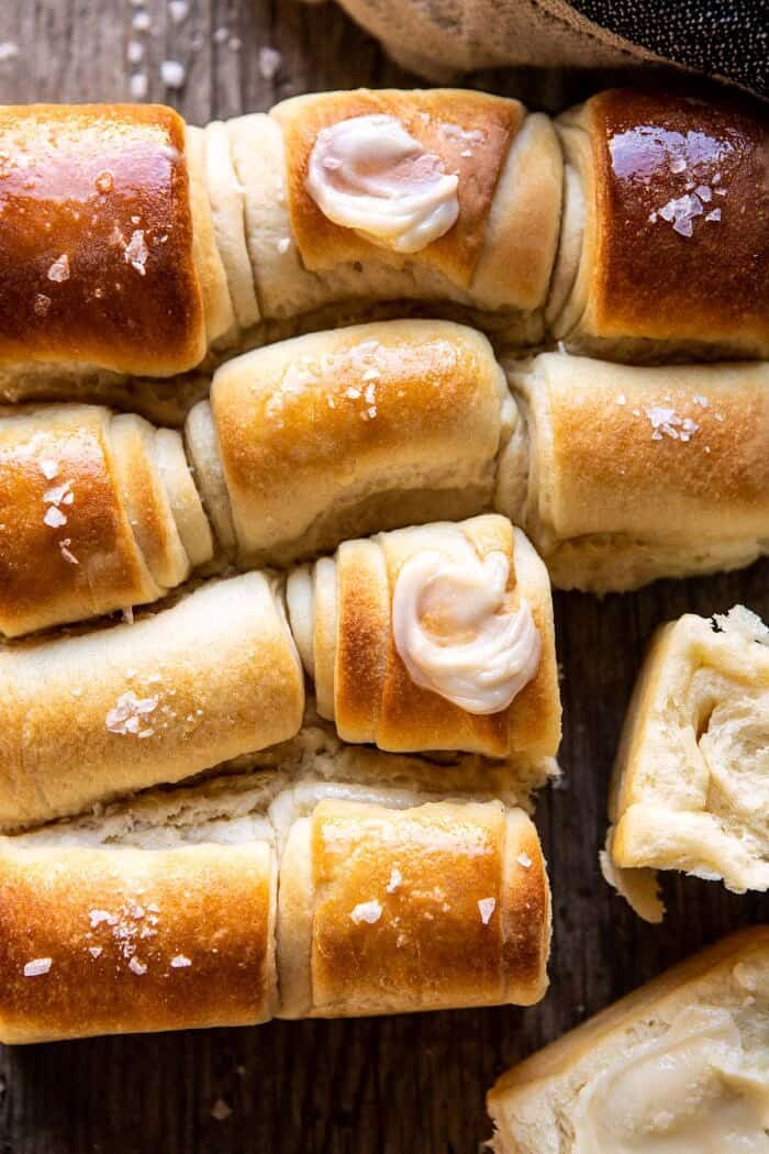 Salted Honey Butter Parker House Rolls | halfbakedharvest.com #rolls #thanksgiving #holidayrecipe overhead close up photo of Salted Honey Butter Parker House Rolls