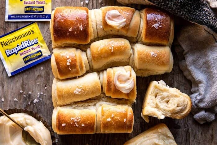 Salted Honey Butter Parker House Rolls | halfbakedharvest.com #rolls #thanksgiving #holidayrecipe horizontal photo of Salted Honey Butter Parker House Rolls
