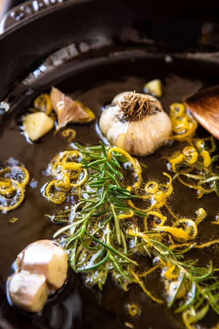 Burrata with Lemon Pepper Salami Bites | halfbakedharvest.com #burrata #appetizer #christmas side angled photo of lemon pepper olive oil in skillet