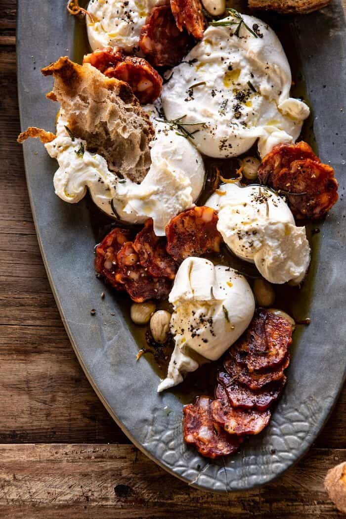 Burrata with Lemon Pepper Salami Bites | halfbakedharvest.com #burrata #appetizer #christmas overhead close up photo of Burrata with Lemon Pepper Salami Bites on serving plate