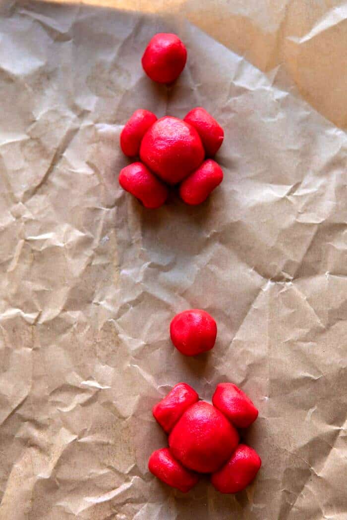 Holly Jolly Santa Cookies | halfbakedharvest.com #santacookies #sugarcookies assembling the Santa cookies