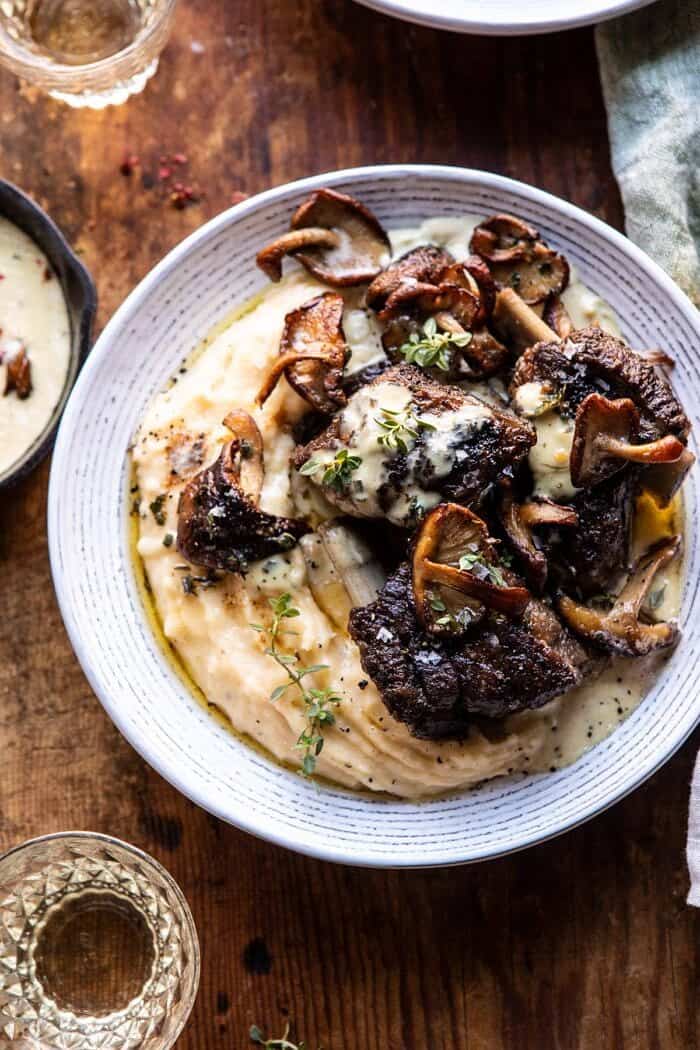 White Wine Braised Short Ribs with Buttered Mushroom Cream Sauce | halfbakedharvest.com #slowcooker #crockpot #shortribs #holiday #christmas overhead close up photo of White Wine Braised Short Ribs with Buttered Mushroom Cream Sauce