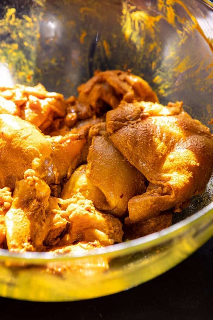 30 Minute Coconut Milk Braised Chicken with Sweet Potatoes and Rice | halfbakedharvest.com #instantpot #easyrecipes #healthy raw chicken sitting in marinade before cooking