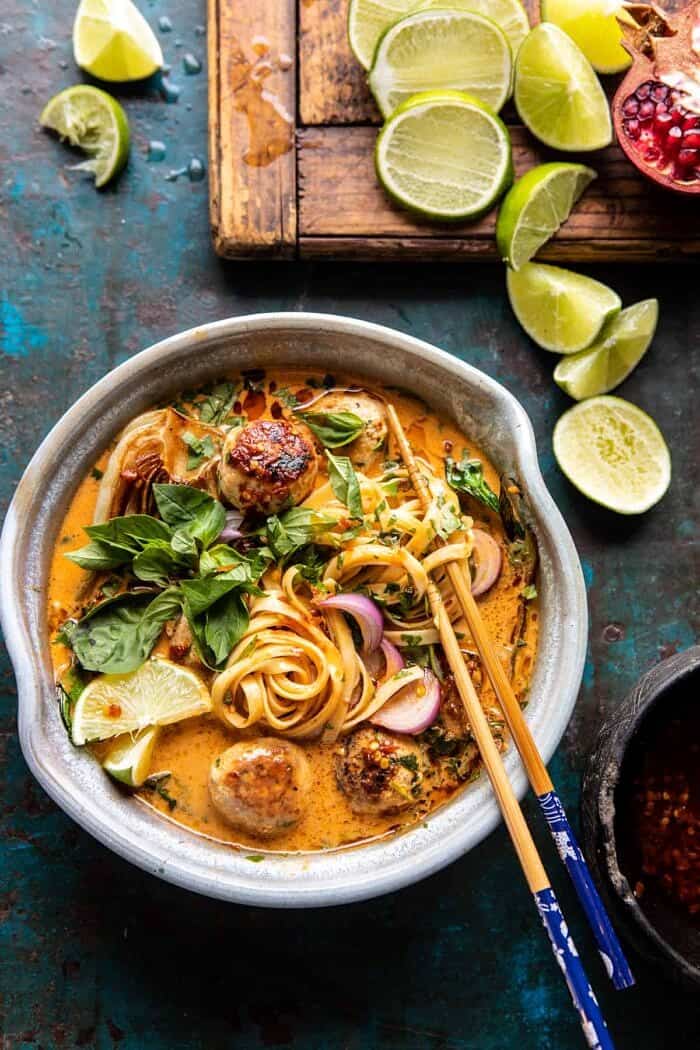 30 Minute Thai Chicken Meatball Khao Soi | halfbakedharvest.com #thai #coconut #healthy overhead close up photo of 30 Minute Thai Chicken Meatball Khao Soi with chopsticks in soup bowl