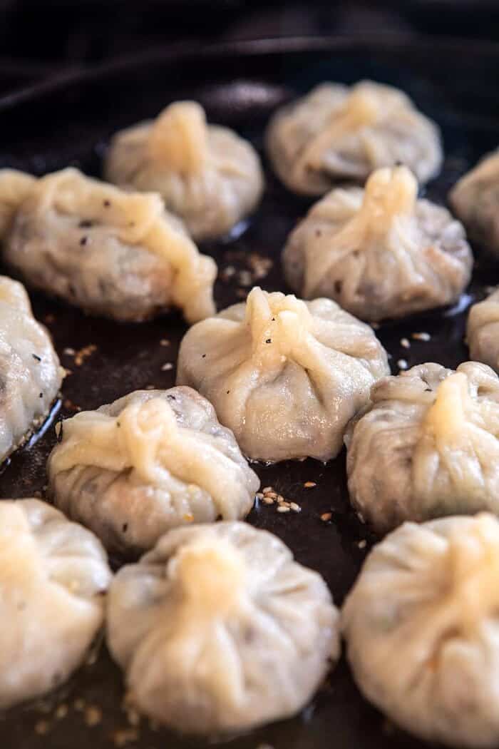 Chinese Mushroom Dumplings with Sweet Chili Ginger Sesame Sauce | halfbakedharvest.com #dumplings #potstickers #chinese Chinese Mushroom Dumplings cooking in skillet