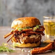 Crispy Quinoa Burgers Topped with Sweet Potato Fries and Beer Caramelized Onions | halfbakedharvest.com #quinoaburger