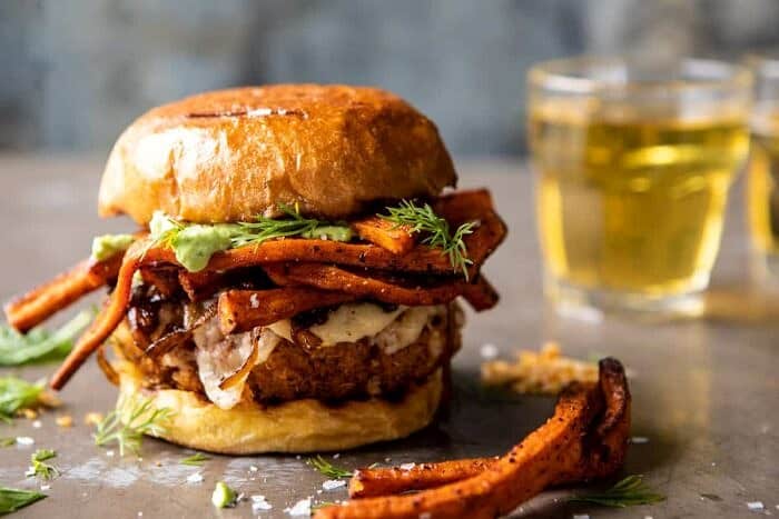 Crispy Quinoa Burgers Topped with Sweet Potato Fries and Beer Caramelized Onions | halfbakedharvest.com #quinoaburger horizontal photo of Crispy Quinoa Burgers Topped with Sweet Potato Fries and Beer Caramelized Onions