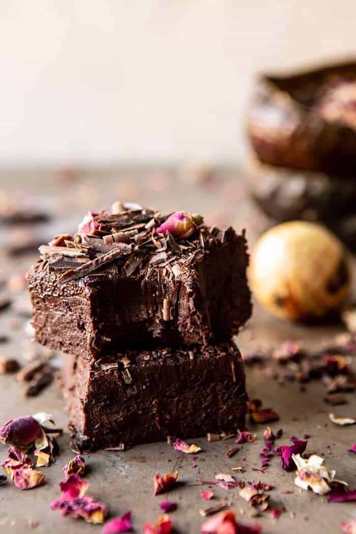 Fudgy Avocado Brownies with Chocolate Fudge Frosting | halfbakedharvest.com #brownies #healthy side angled photo of Fudgy Avocado Brownies with Chocolate Fudge Frosting stack on top of each other