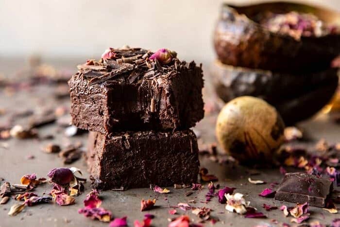 Fudgy Avocado Brownies with Chocolate Fudge Frosting | halfbakedharvest.com #brownies #healthy horizontal photo of Fudgy Avocado Brownies with Chocolate Fudge Frosting stack on top of each other