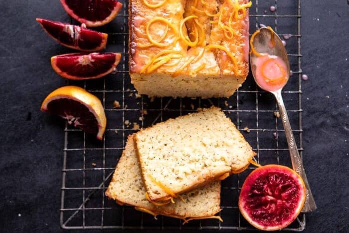Lemon Poppyseed Cake with Citrus Honey Glaze | halfbakedharvest.com #lemon #cake #winter horizontal photo of Lemon Poppyseed Cake with Citrus Honey Glaze with 2 pieces of cake cut