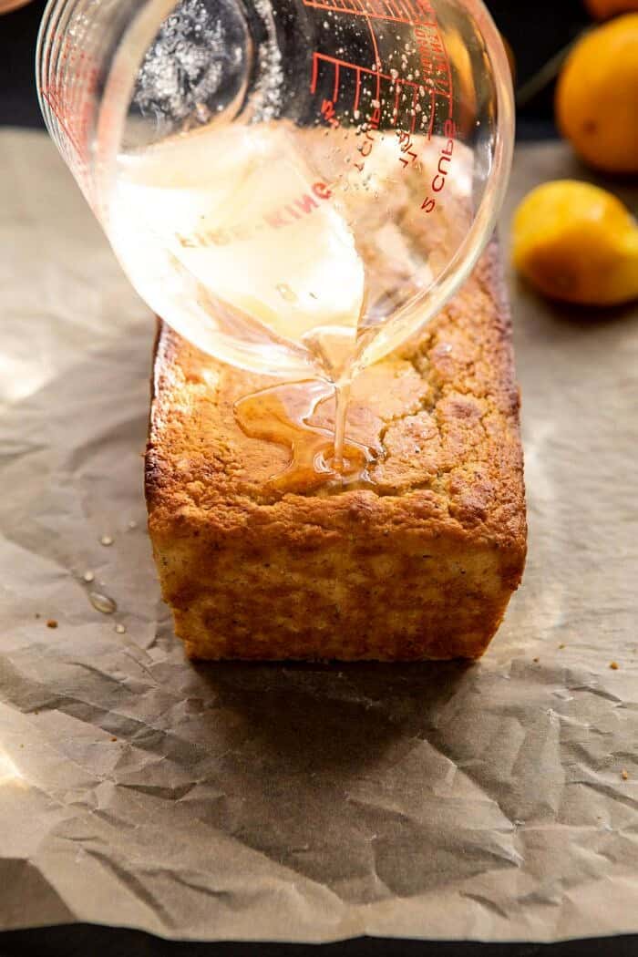 Lemon Poppyseed Cake with Citrus Honey Glaze | halfbakedharvest.com #lemon #cake #winter drizzling honey glaze over cake