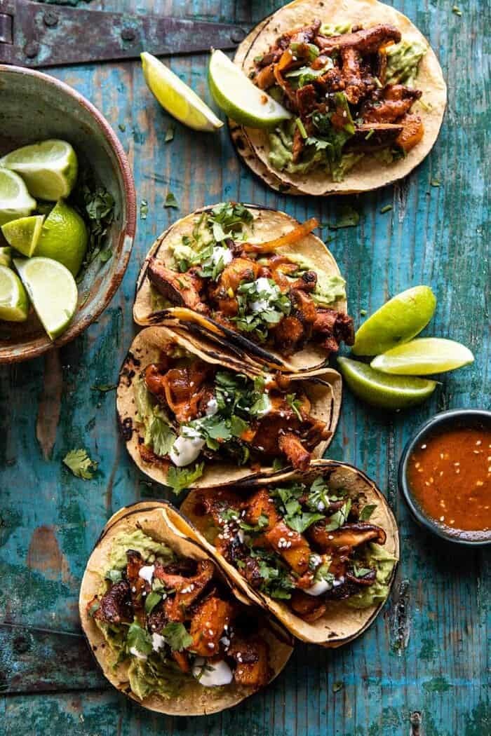 Mushroom Al Pastor Tacos with Garlic Lime Special Sauce | halfbakedharvest.com #vegan #mushrooms #tacos overhead photo of Mushroom Al Pastor Tacos with Garlic Lime Special Sauce