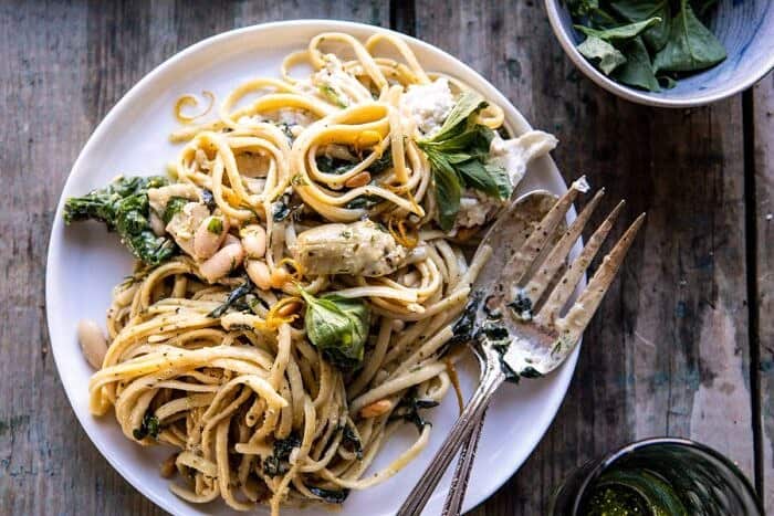 One Pot Creamy Tuscan Pesto and Artichoke Pasta | halfbakedharvest.com #onepot #pasta horizontal photo of One Pot Creamy Tuscan Pesto and Artichoke Pasta on serving plate