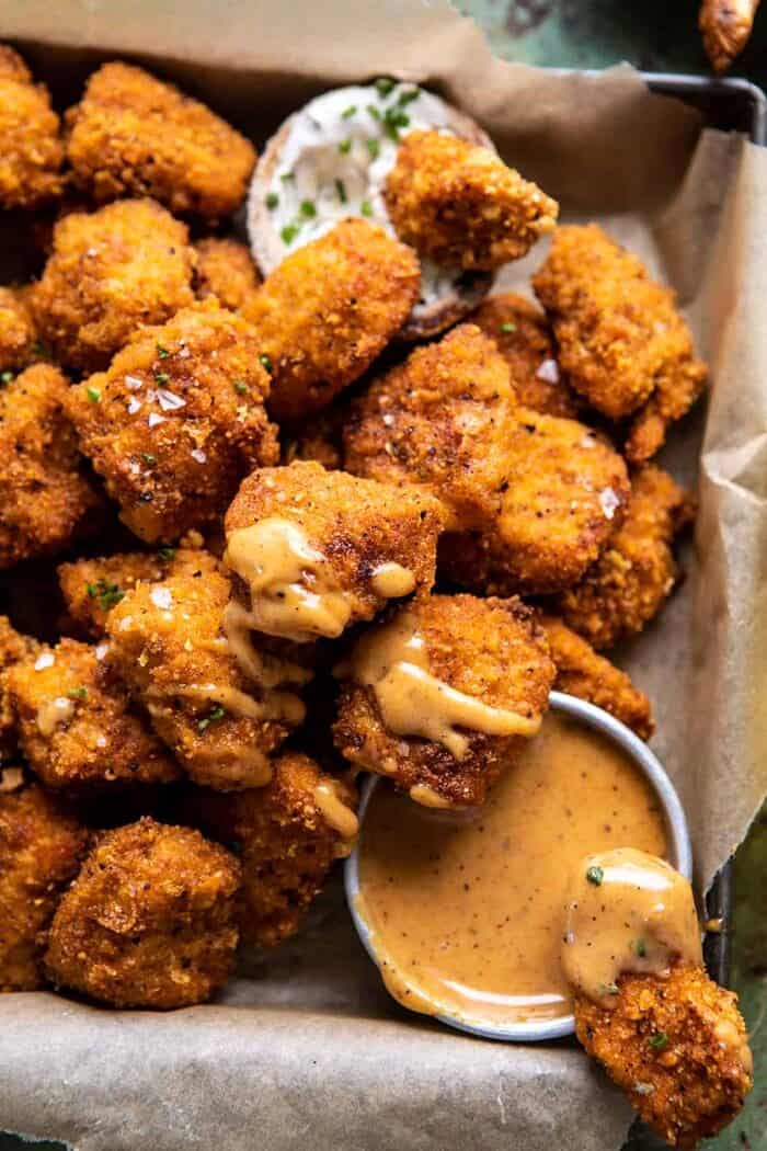Oven Fried Cajun Popcorn Chicken with Creamy Honey Mustard | halfbakedharvest.com #chickenfingers #easyrecipes side angled close up photo of Oven Fried Cajun Popcorn Chicken with Creamy Honey Mustard
