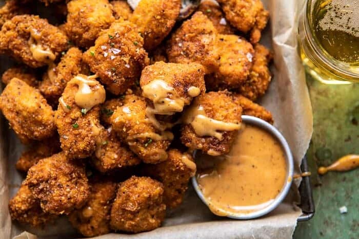 Oven Fried Cajun Popcorn Chicken with Creamy Honey Mustard | halfbakedharvest.com #chickenfingers #easyrecipes horizontal photo of Oven Fried Cajun Popcorn Chicken with Creamy Honey Mustard
