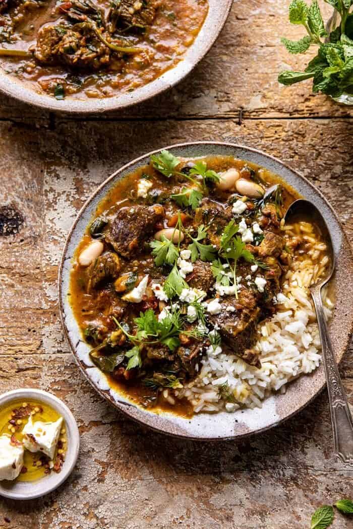 Persian Herb and Beef Stew | halfbakedharvest.com #beefstew #whitebeans #healthy overhead close up photo of Persian Herb and Beef Stew with spoon in bowl