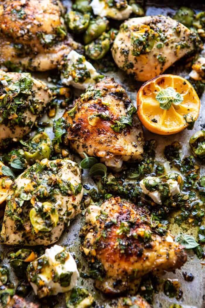 Roasted Garlic Butter Chicken with Lemon Olive Dressing | halfbakedharvest.com #chicken #sheetpan #easyrecipes close up overhead photo of Roasted Garlic Butter Chicken with Lemon Olive Dressing on sheet pan