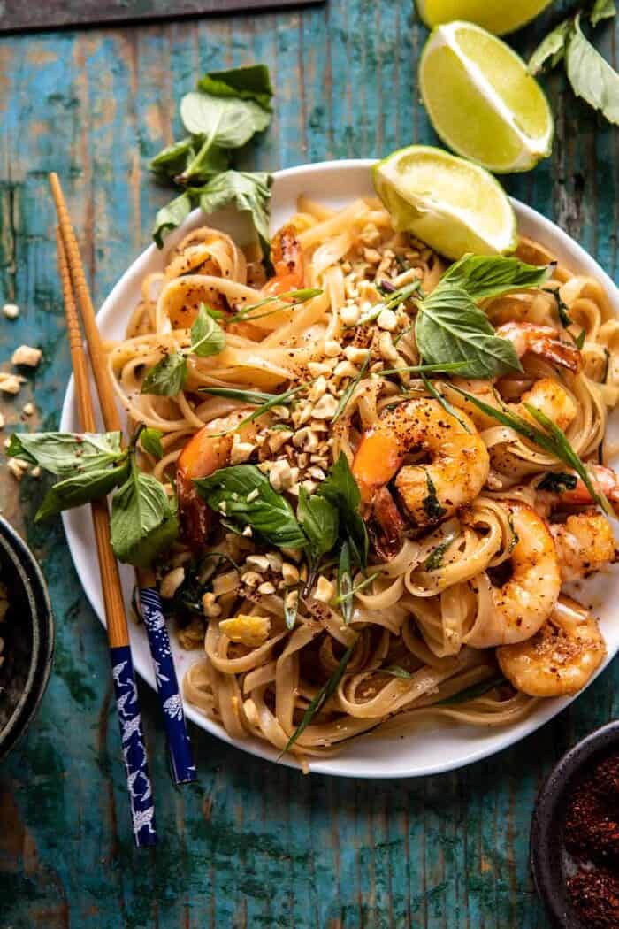 Better Than Takeout Garlic Butter Shrimp Pad Thai | halfbakedharvest.com #padthai #garlicbutter overhead close up photo of Better Than Takeout Garlic Butter Shrimp Pad Thai with chopsticks on the side of plate