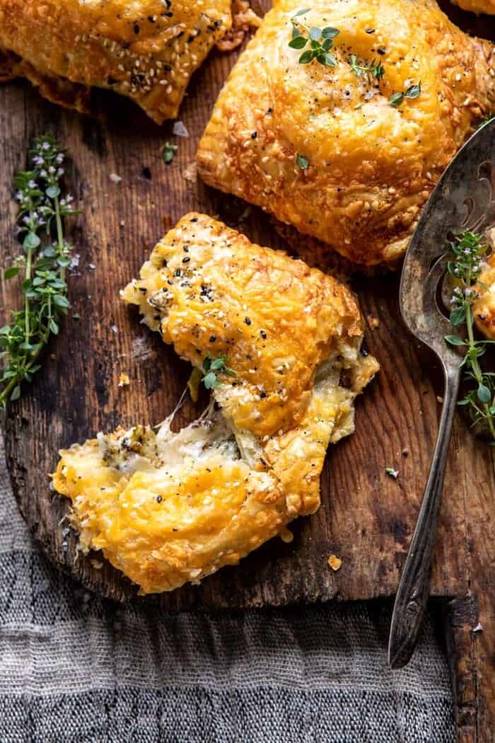 Flaky Broccoli Cheddar Soup Mini Pies | halfbakedharvest.com overhead photo of Flaky Broccoli Cheddar Soup Mini Pies torn in half to expose the filling