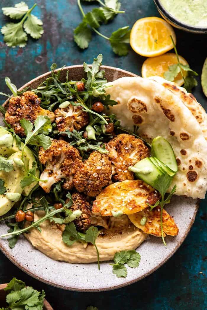 overhead close up photo of Cauliflower Shawarma with Green Tahini and Fried Halloumi 