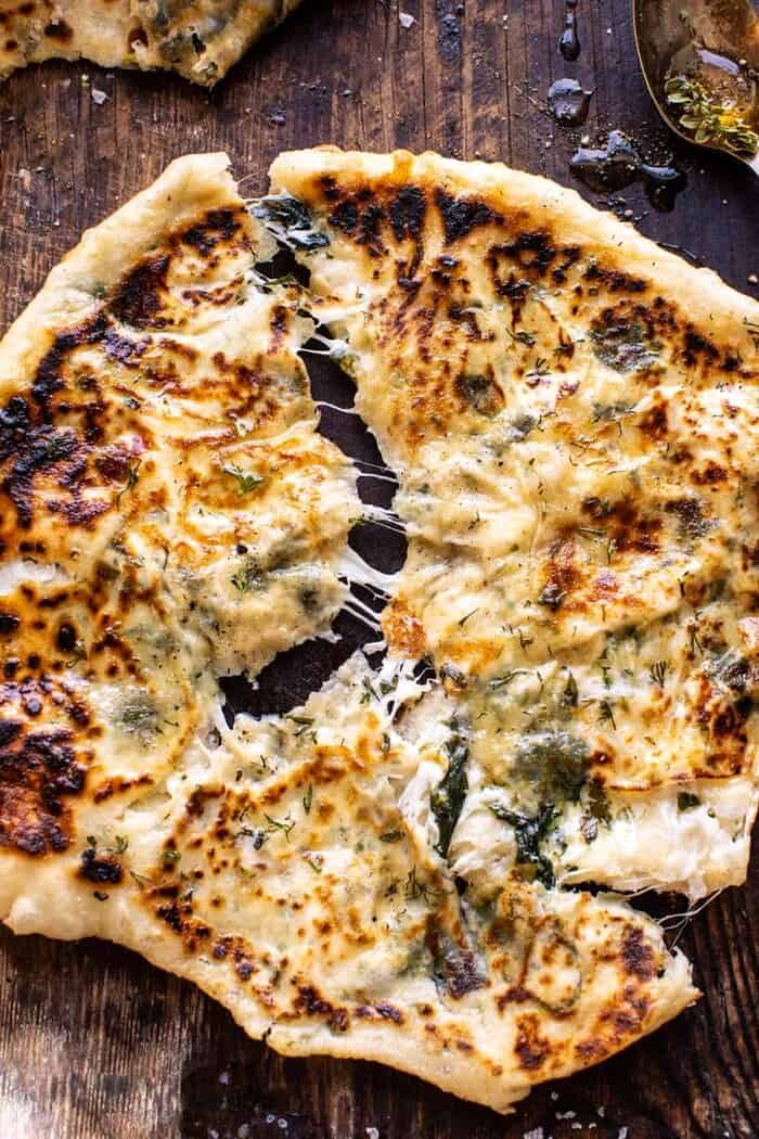 Cheesy Herb Stuffed Naan | halfbakedharvest.com overhead close up photo of Cheesy Herb Stuffed Naan