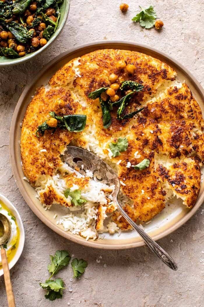 Crispy Persian Rice (Tahdig) with Spiced Golden Chickpeas | halfbakedharvest.com overhead photo of Crispy Persian Rice (Tahdig) with Spiced Golden Chickpeas with spoon in rice