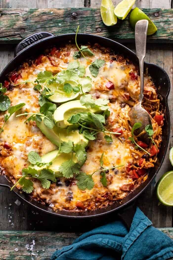 One Skillet Cheesy Cuban Chicken Rice Bake | halfbakedharvest.com Overhead photo of One Skillet Cheesy Cuban Chicken Rice Bake with spoon in rice