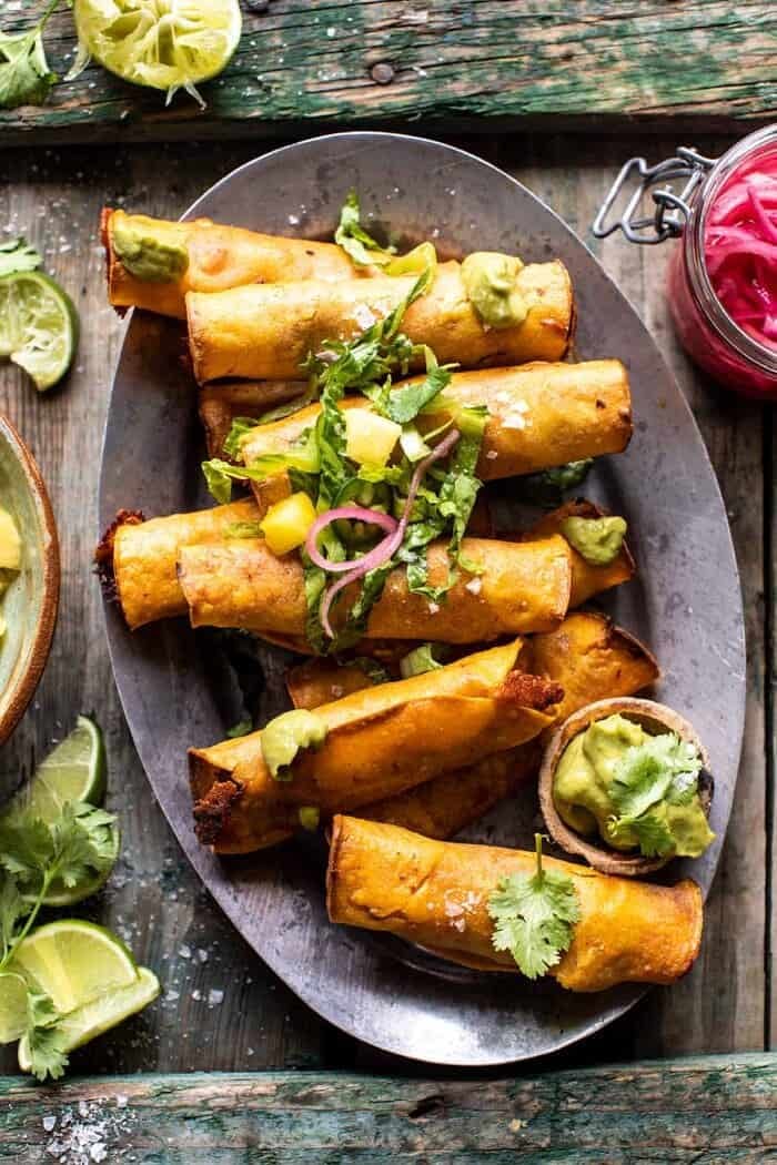 Crispy Chicken Tinga Taquitos with Salty Lime Avocado Crema | halfbakedharvest.com