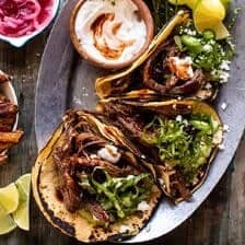 Crockpot Carne Asada Tacos with Cilantro Lime Garlic Sauce | halfbakedharvest.com