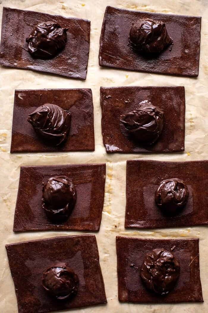 Homemade Chocolate Fudge Pop Tarts | halfbakedharvest.com prep photo of Chocolate dough with fudge sauce on top
