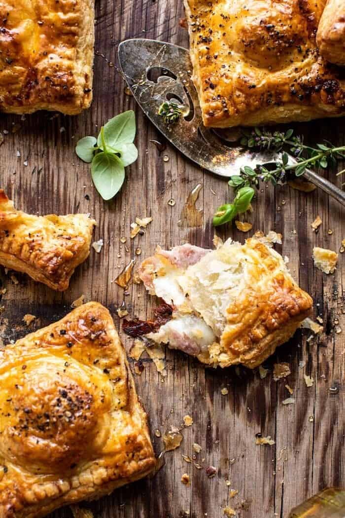 Prosciutto Caprese Puff Pastries with Peppery Thyme Honey | halfbakedharvest.com overhead photo of Prosciutto Caprese Puff Pastry torn in half to expose the filling inside