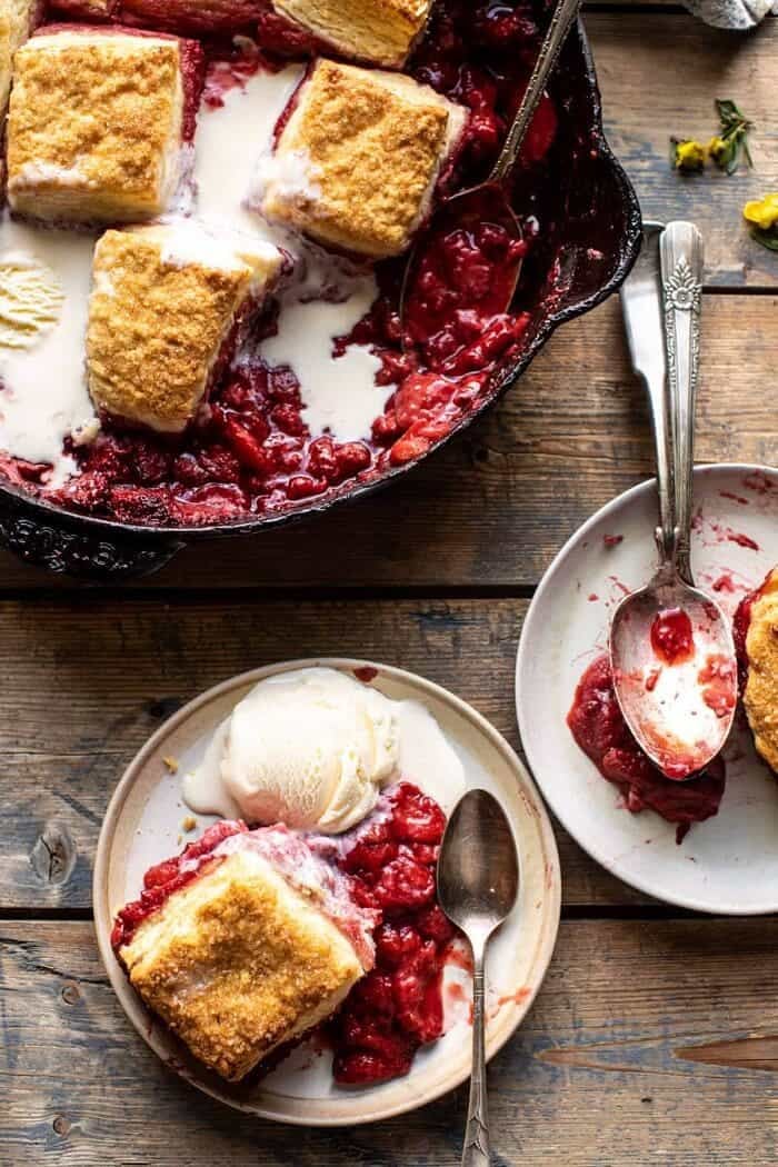 Skillet Strawberry Bourbon Cobbler with Layered Cream Cheese Biscuits | halfbakedharvest.com overhead photo of Skillet Strawberry Bourbon Cobbler with Layered Cream Cheese Biscuits on plate