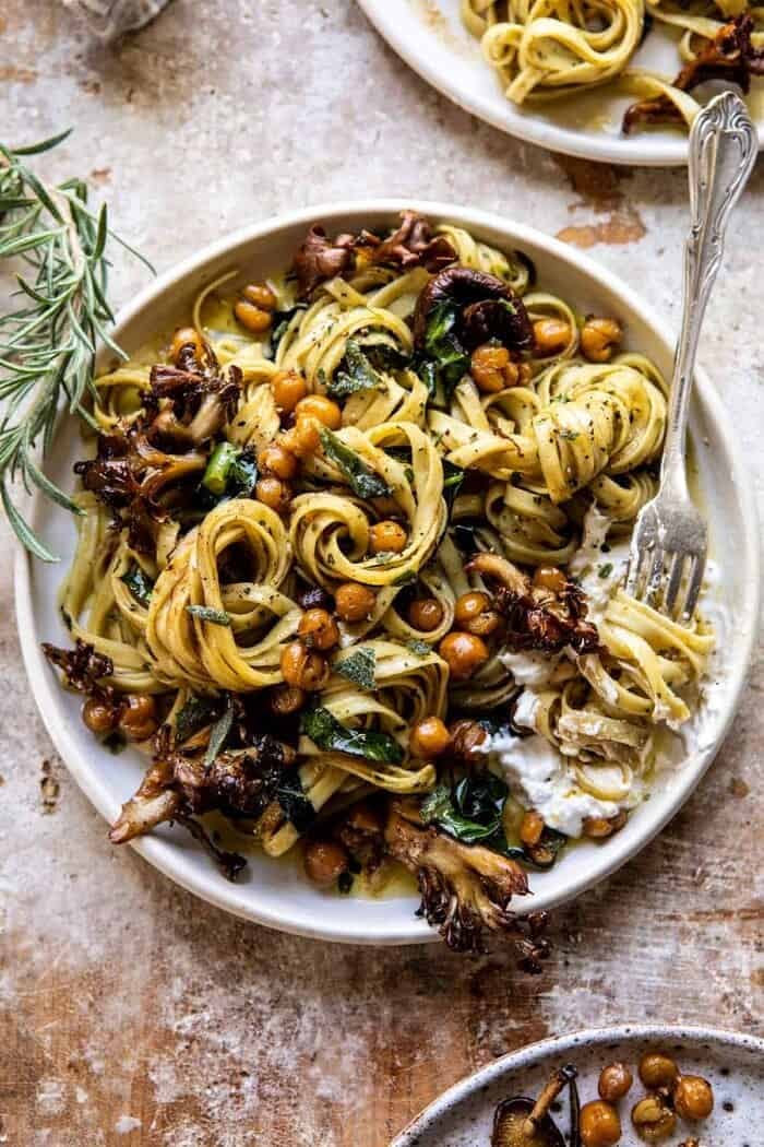 Slow Roasted Mushroom Pasta with Crisp Rosemary Chickpeas | halfbakedharvest.com overhead photo of Slow Roasted Mushroom Pasta with Crisp Rosemary Chickpeas with fork twirling pasta on plate