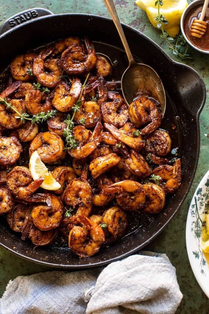 15 Minute Cajun Hot Honey Butter Shrimp | halfbakedharvest.com overhead photo of 15 Minute Cajun Hot Honey Butter Shrimp in skillet with spoon