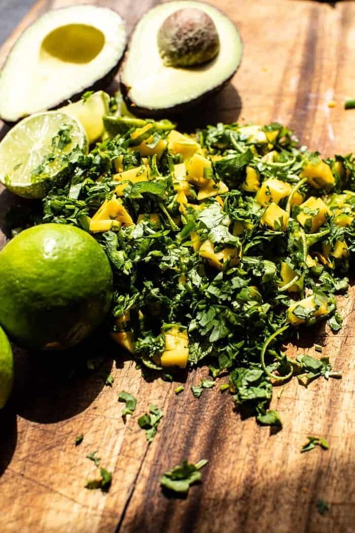 20 Minute Honey Garlic Butter Shrimp | halfbakedharvest.com prep photo of mango salsa on cutting board