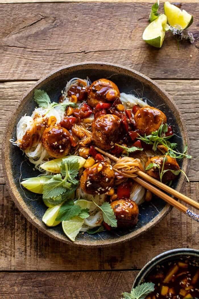 30 Minute Sticky Thai Meatballs with Sesame Noodles | halfbakedharvest.com overhead photo of 30 Minute Sticky Thai Meatballs with Sesame Noodles and chopsticks in bowl with noodles