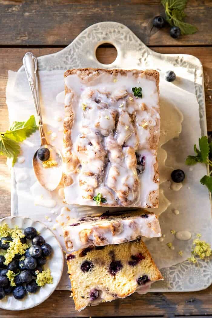 Blueberry Lemon Thyme Cake | halfbakedharvest.com overhead photo of Blueberry Lemon Thyme Cake with 2 slices cut