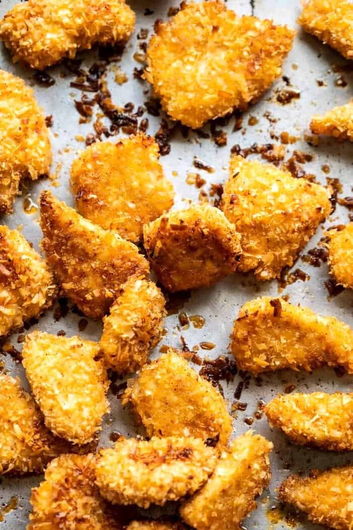 Coconut Popcorn Chicken with Sweet Thai Chili Lime Sauce | halfbakedharvest.com overhead prep photo of Coconut Popcorn Chicken on baking sheet