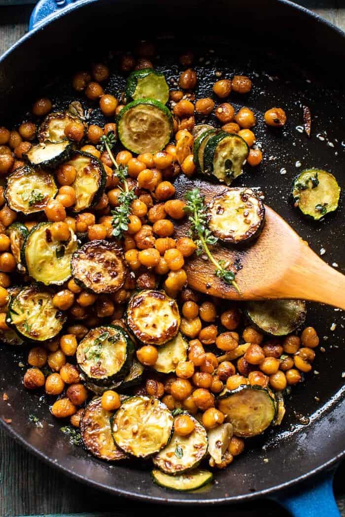 Crispy Lemon Feta with Spiced Chickpeas and Basil Orzo | halfbakedharvest.com overhead photo of Spiced Chickpeas and zucchini in skillet